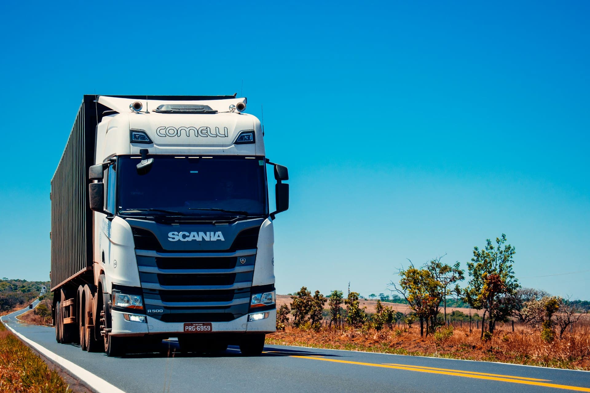 Fleet of trucks on highway at sunset